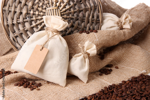 Εκτύπωση καμβά Sacks with coffee beans on wooden table, on sackcloth