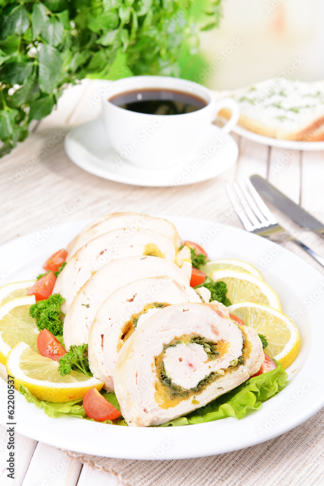 Delicious chicken roll on plate on table close-up