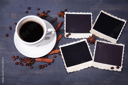 Coffee cup and old blank photos and spices  on wooden