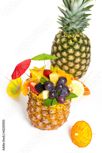 Fototapeta Naklejka Na Ścianę i Meble -  Salad of pineapple, oranges and other fruits in a pineapple