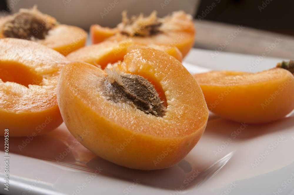 fresh cut apricot close up on white