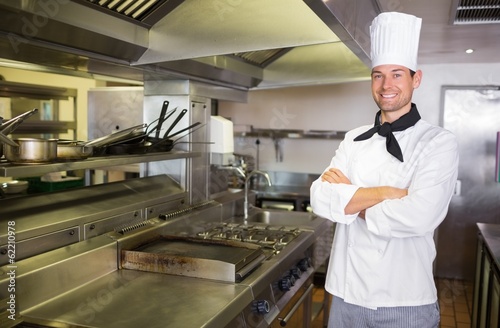 Smiling male cook with arms crossed in the kitchen