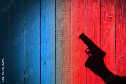 Hand with a gun on a wooden fence, XXXL image