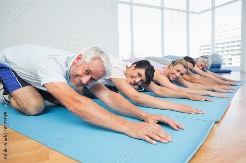 Portrait of fitness group bowing in row