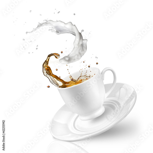 Splash of tea with milk in the falling cup isolated on white