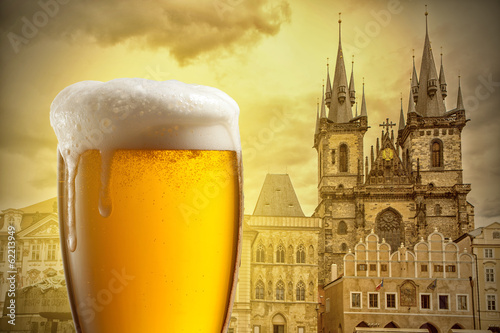 Glass of beer against Tyn Church in Prague