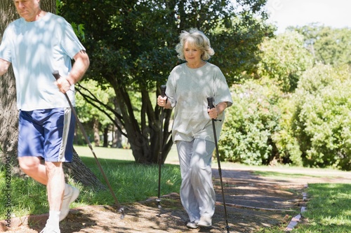 Mature couple Nordic walking at park