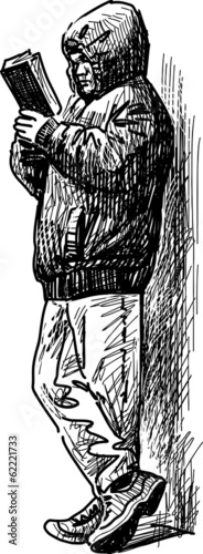 Man with book on a walk