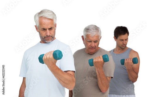 Three men exercising with dumbbells in row