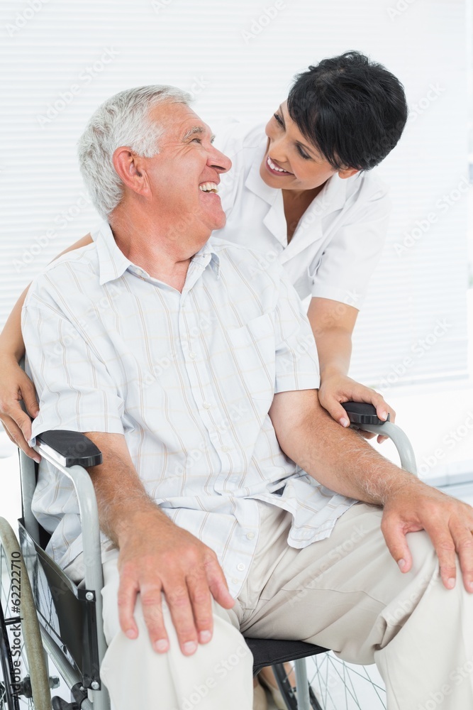 Fototapeta premium Portrait of a nurse with senior patient sitting in wheelchair