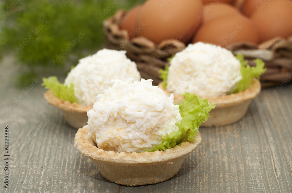 Tartlets with cheese and egg balls and eggs in the basket. Tartlets with cheese and egg balls and eggs in the basket.
