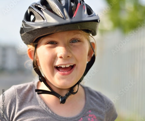 Young girl in a bicycle helmet.