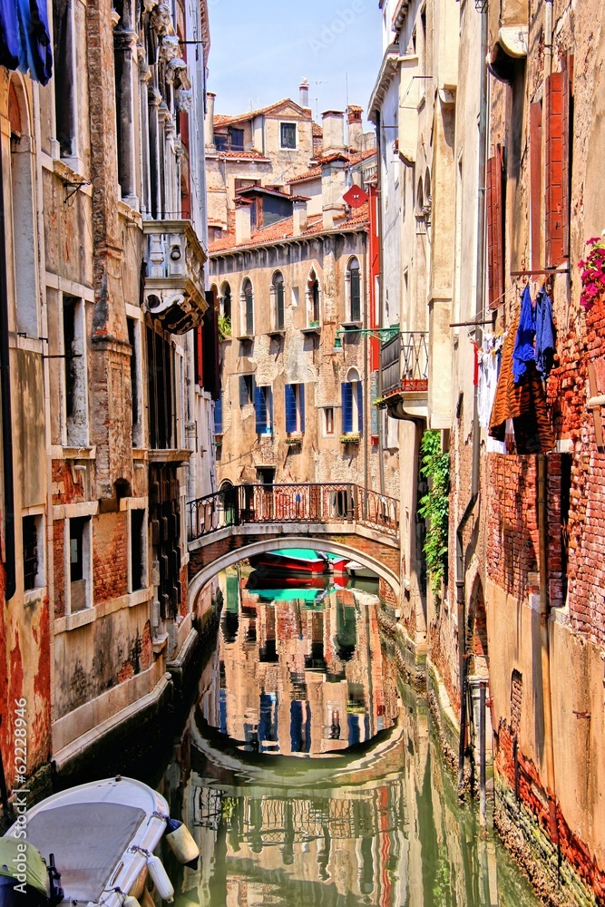 Quaint canal in Venice with reflection, Italy
