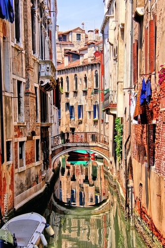 Quaint canal in Venice with reflection, Italy