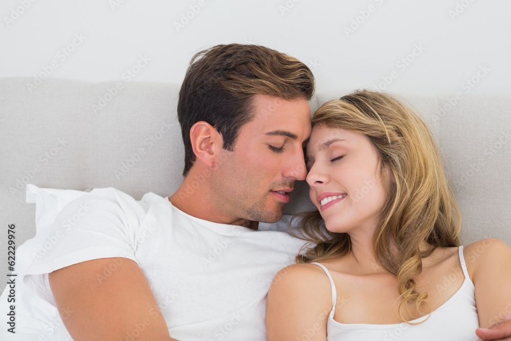 Close-up portrait of a relaxed couple in bed