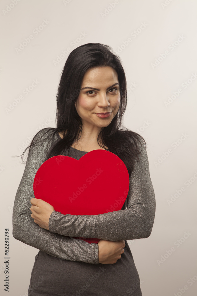 girl holding a heart in her hands girl holding a heart in her hands