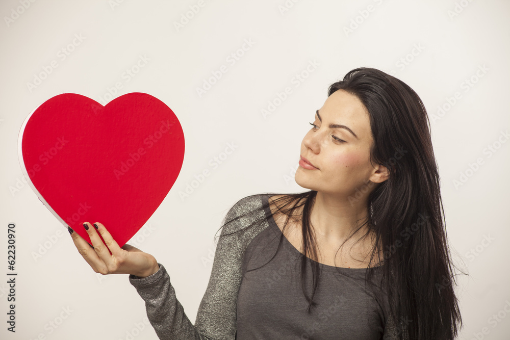 girl holding a heart in her hands girl holding a heart in her hands