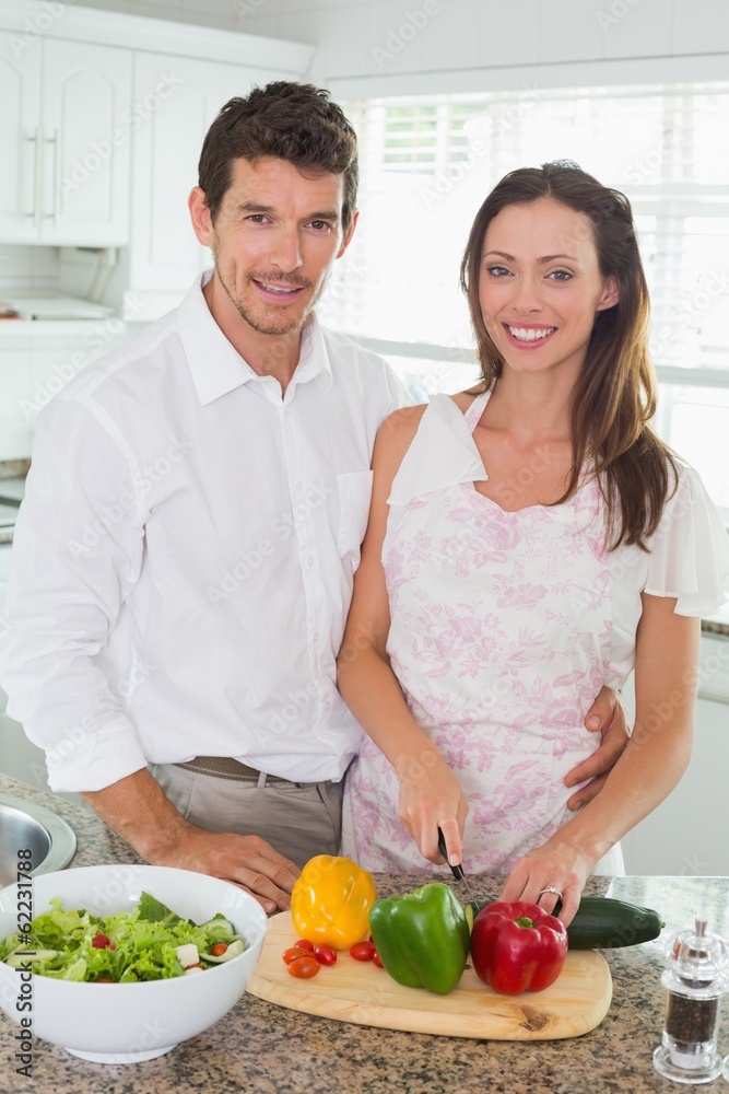 Portrait of a couple cutting vegetables in kitchen Portrait of a couple cutting vegetables in kitchen