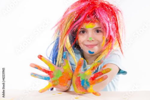 Beautiful little girl with hands in the paint