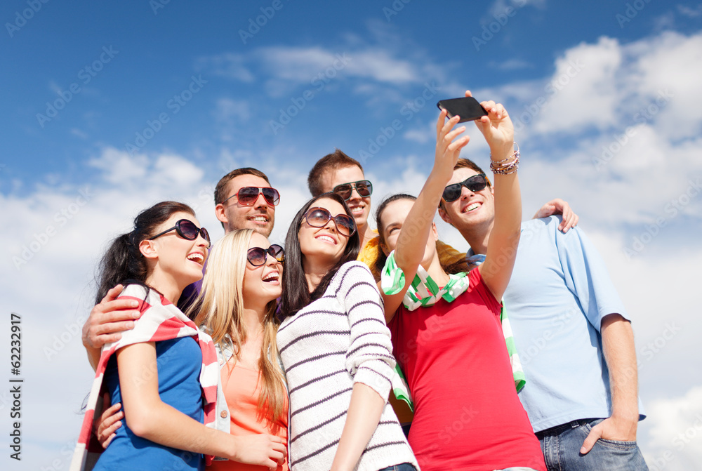 group of friends taking picture with smartphone group of friends taking picture with smartphone