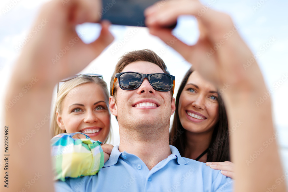 friends taking picture with smartphone camera friends taking picture with smartphone camera