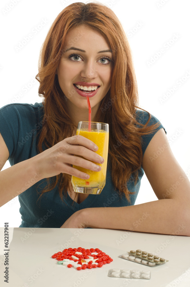 Woman choosing between vitamin pills and an organic smoothie Woman choosing between vitamin pills and an organic smoothie