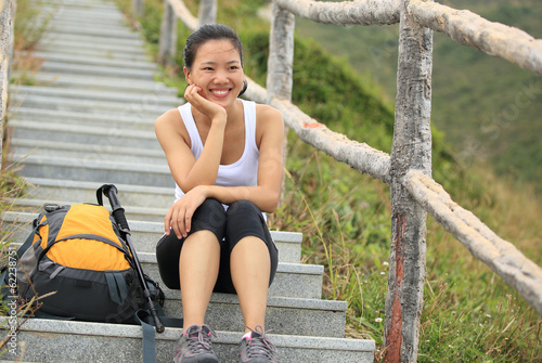woman hiker sit rest on mountain stone stairs