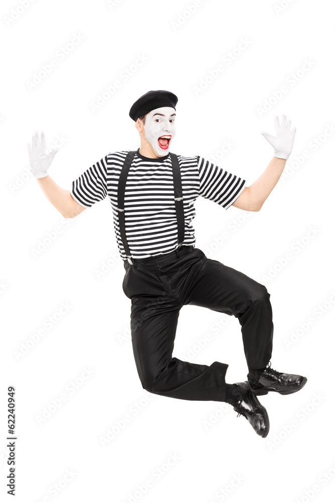 Full length portrait of mime artist jumping with joy
