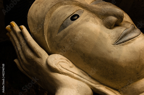 Buddha statue face reclining on hand