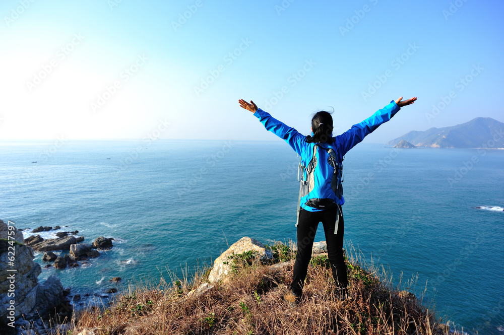 cheering woman hiker seaside mountain peak cheering woman hiker seaside mountain peak