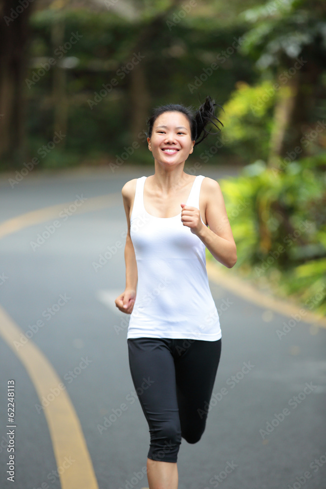 fitness woman runner running on country road fitness woman runner running on country road