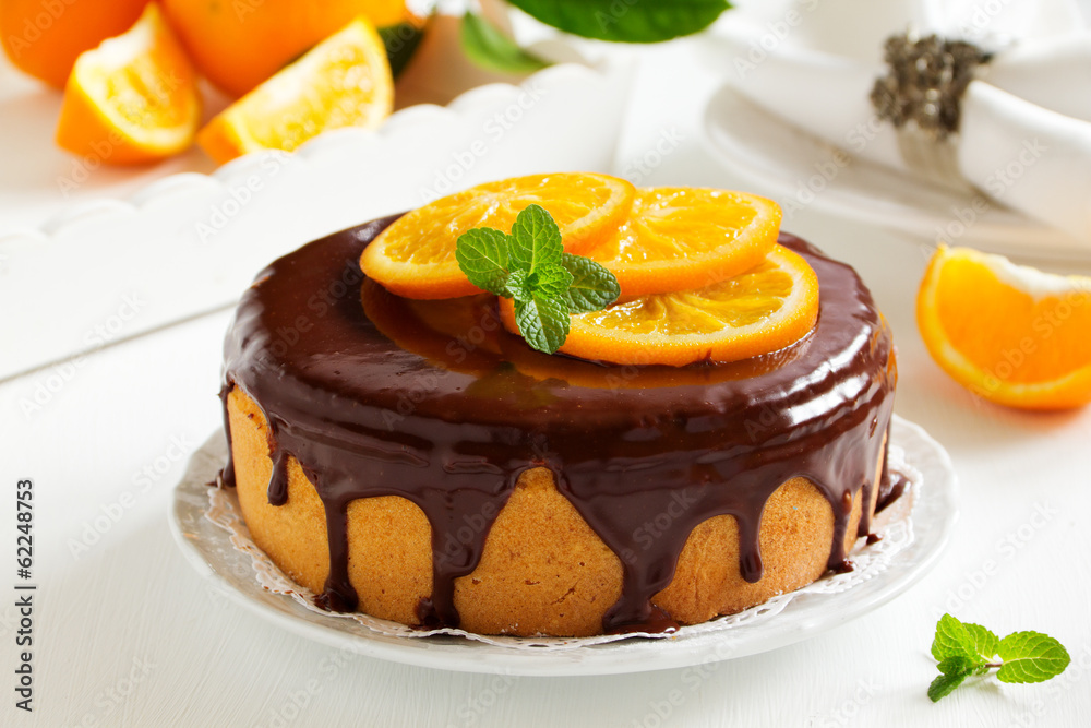 Orange cake with chocolate and orange slices.