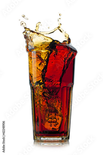 Splashing cola in glass. Isolated on white background