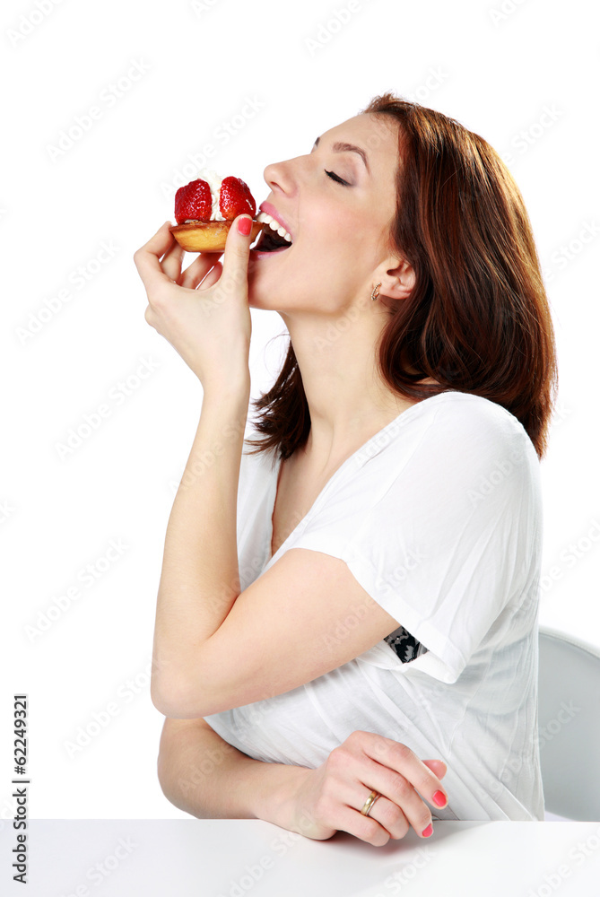 Woman eating fresh strawberry cake Woman eating fresh strawberry cake