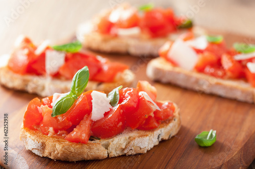 Italian bruschetta with tomatoes, parmesan, garlic and olive oil