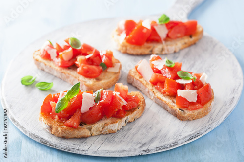 Italian bruschetta with tomatoes, parmesan, garlic and olive oil