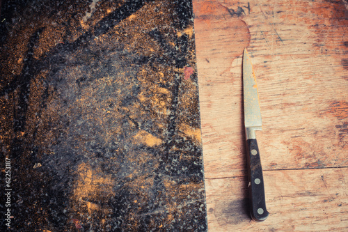 Knife and chopping board covered in spices