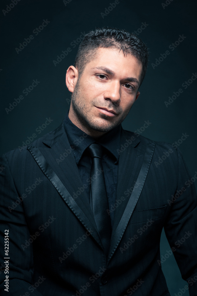 Fototapeta premium Elegant man close up portrait against dark background.