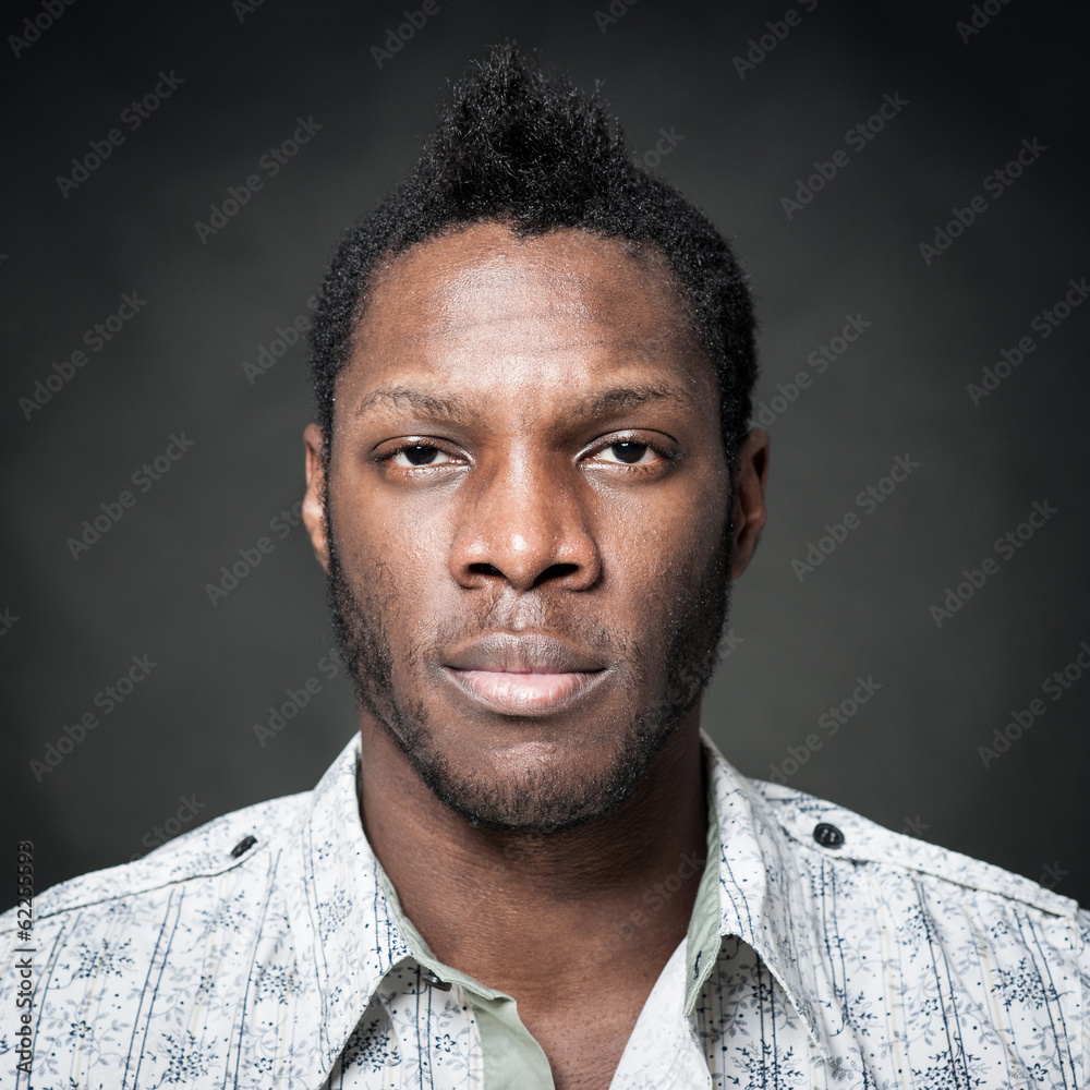 Obraz premium Intense man close up portrait against dark background.