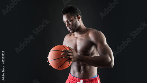 Portrait of confident young black man shirtless with basket ball