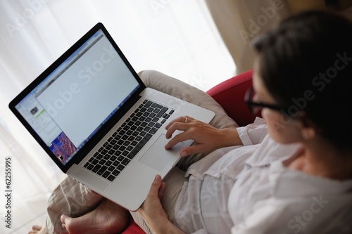 woman using a laptop computer at home