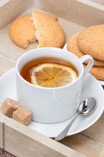 black tea with lemon and cookies, vertical © cook_inspire
