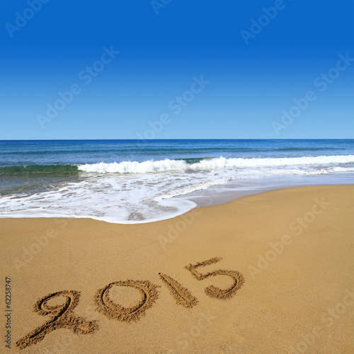 2015 written on sandy beach