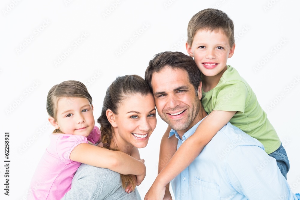 Cheerful young family looking at camera together Cheerful young family looking at camera together