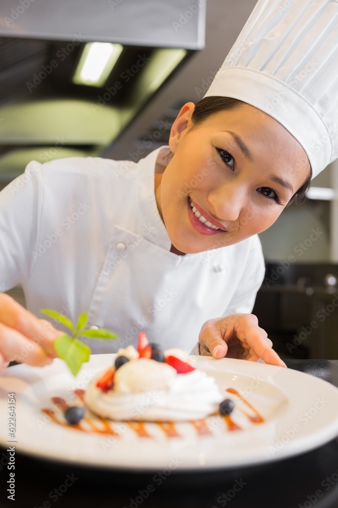 Closeup of a smiling chef garnishing food Closeup of a smiling chef garnishing food