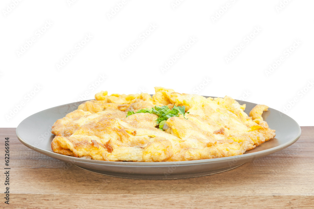 closeup of omelette, typical rolled plain omelette on a white ba closeup of omelette, typical rolled plain omelette on a white ba