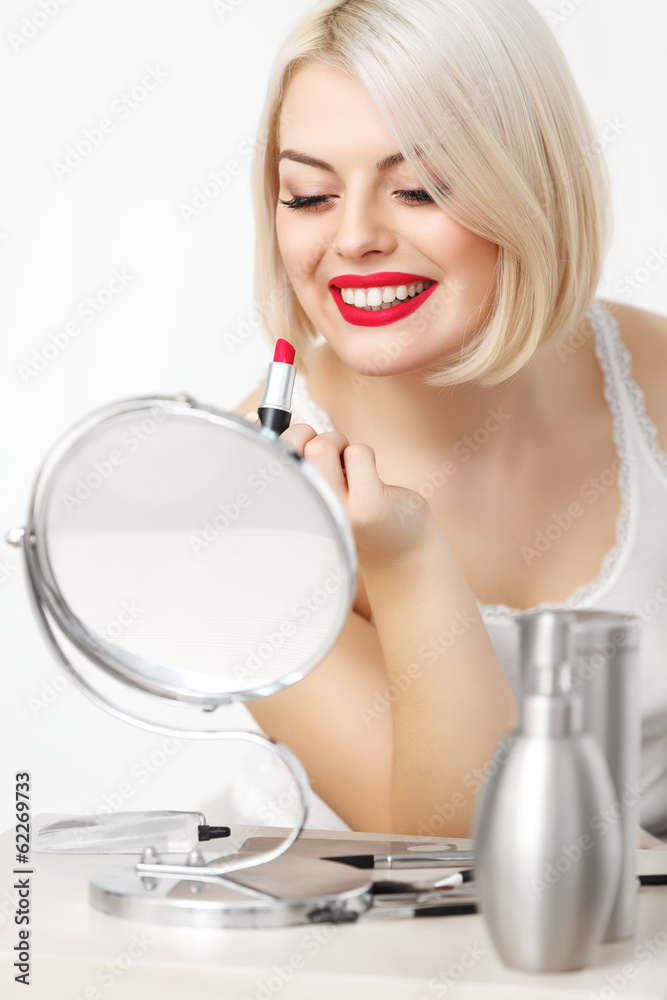 Woman applies red Lipstick Red Lips and Blond Hair. Daily Makeup Woman applies red Lipstick Red Lips and Blond Hair. Daily Makeup