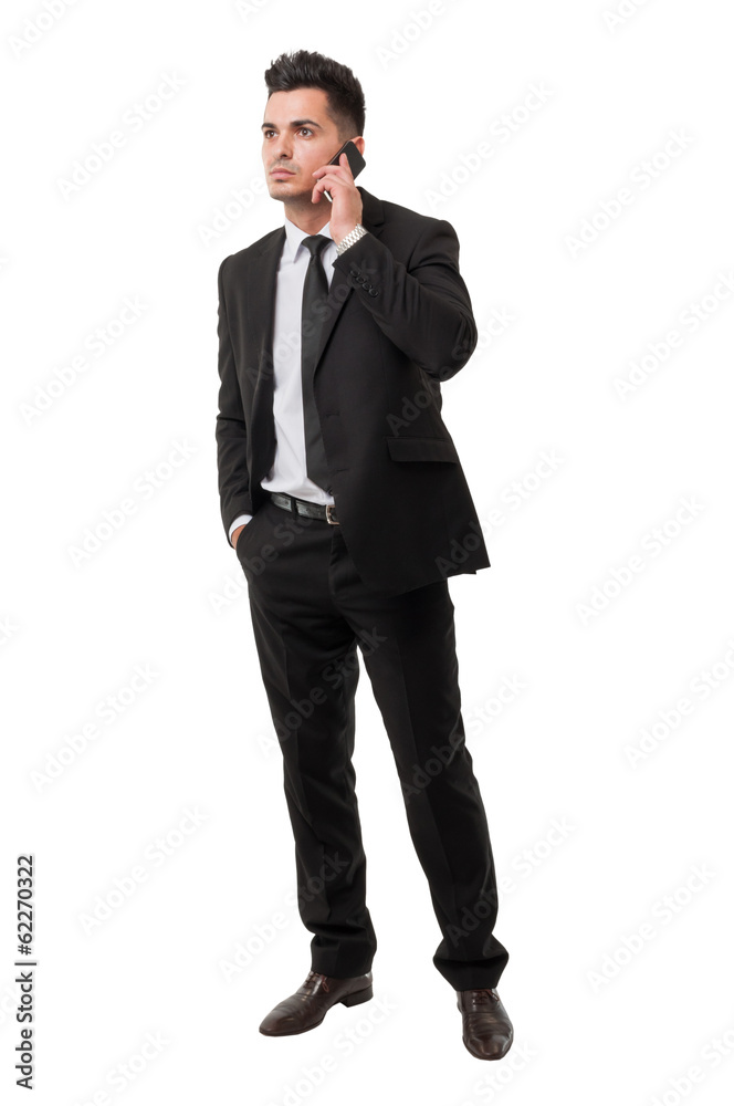Modern and elegant business man answering his phone Modern and elegant business man answering his phone