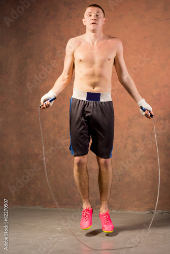 Young boxer training with a skipping rope