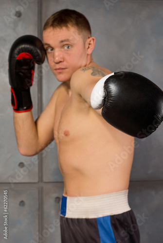 Determined boxer throwing a jab or punch © kolotype